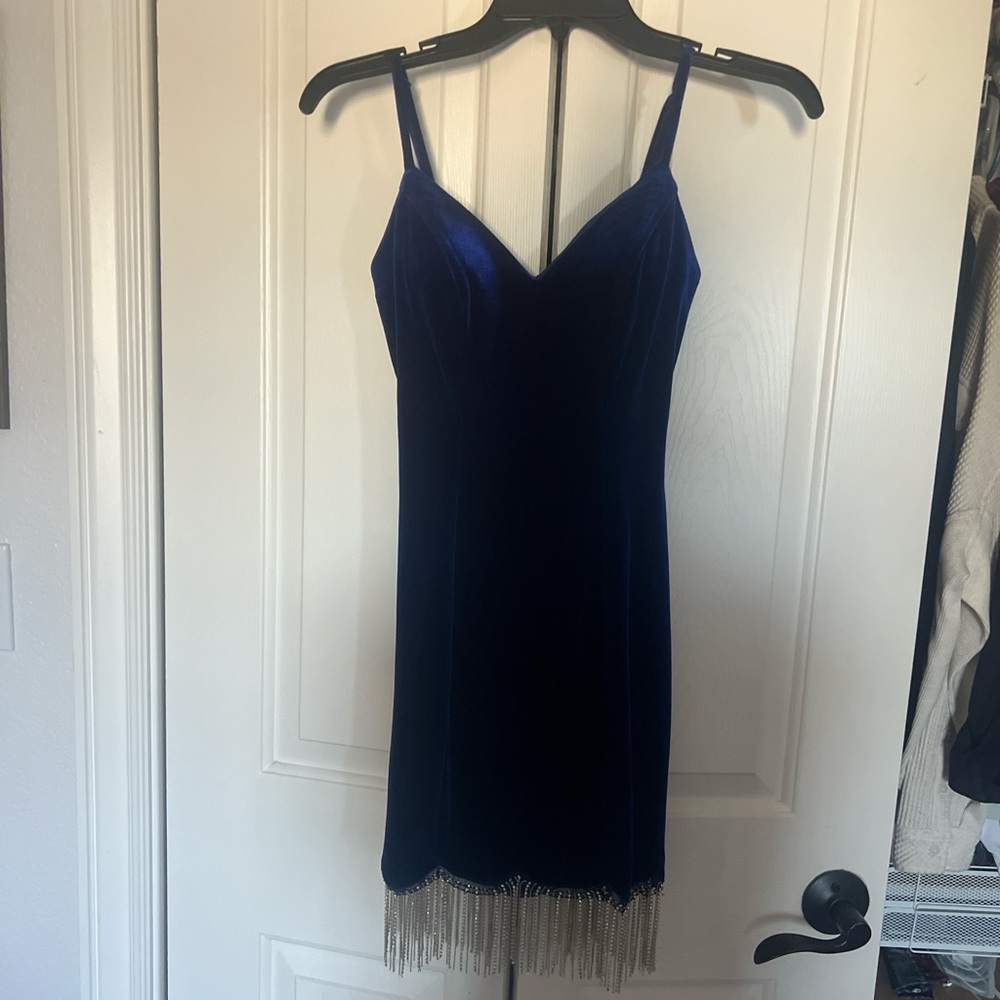 Navy blue velvet dress with silver tassels and a V-neckline.
